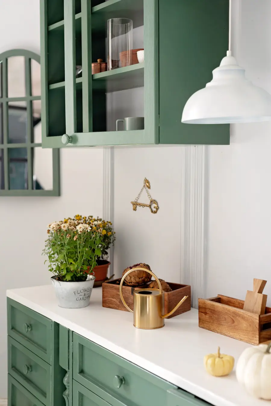 A white kitchen with green cabinets